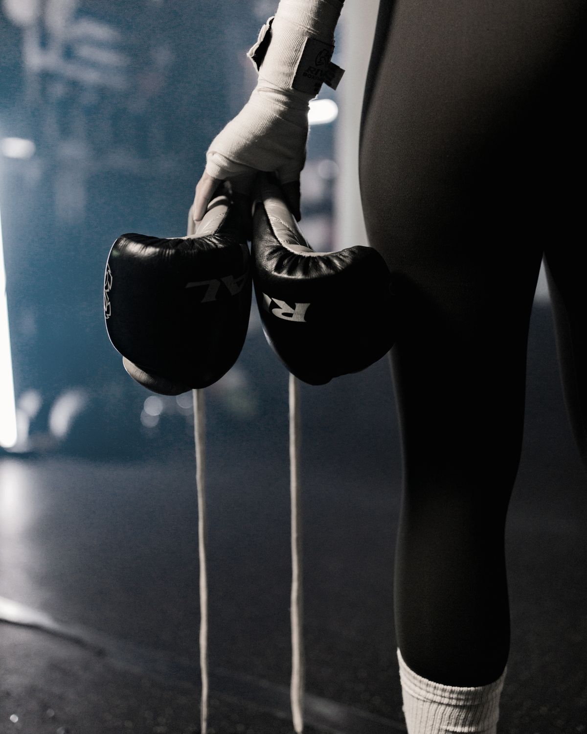 Wrapped hands carrying gloves onto the mats