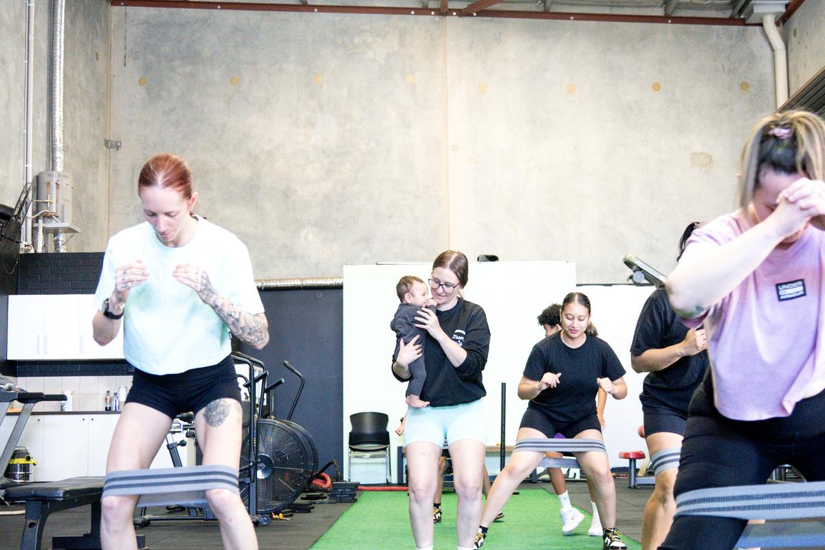 A Strong class working through banded squats at the studio