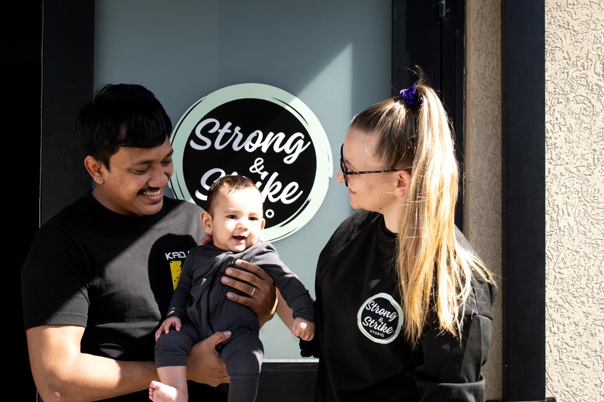 Maddie and her family outside the studio door